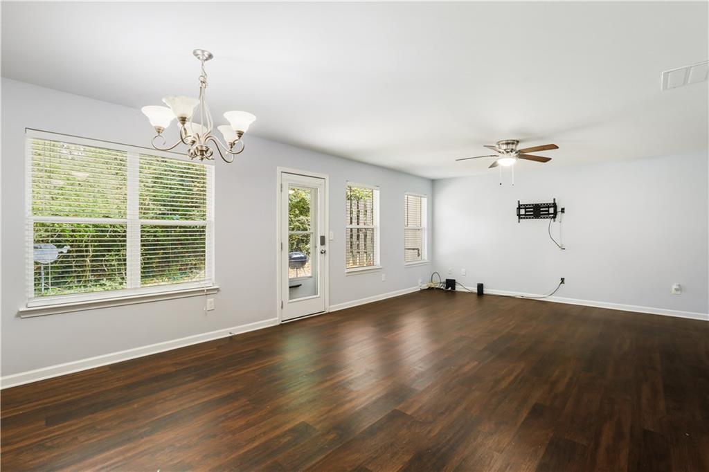 1221 Rockfield Circle Norcross, GA 30093 - Photo 4 of 10 a view of an empty room with wooden floor and a window