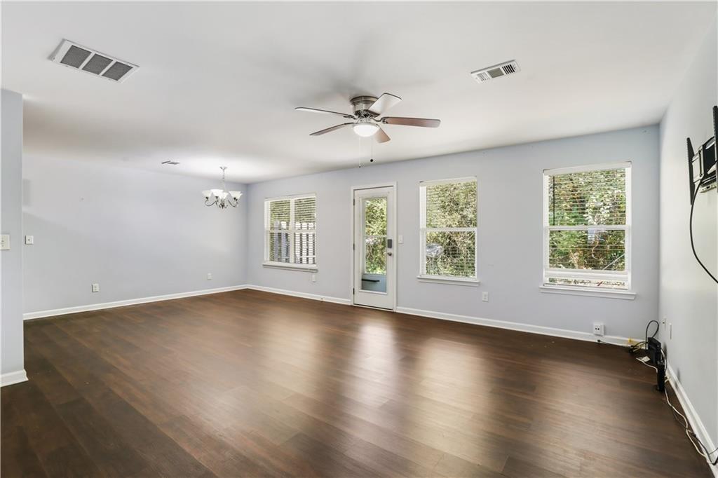 1221 Rockfield Circle Norcross, GA 30093 - Photo 7 of 10 a view of an empty room with wooden floor and a window