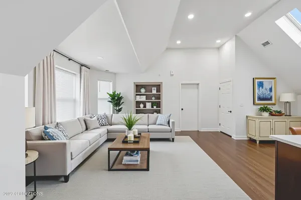 a living room with furniture and wooden floor