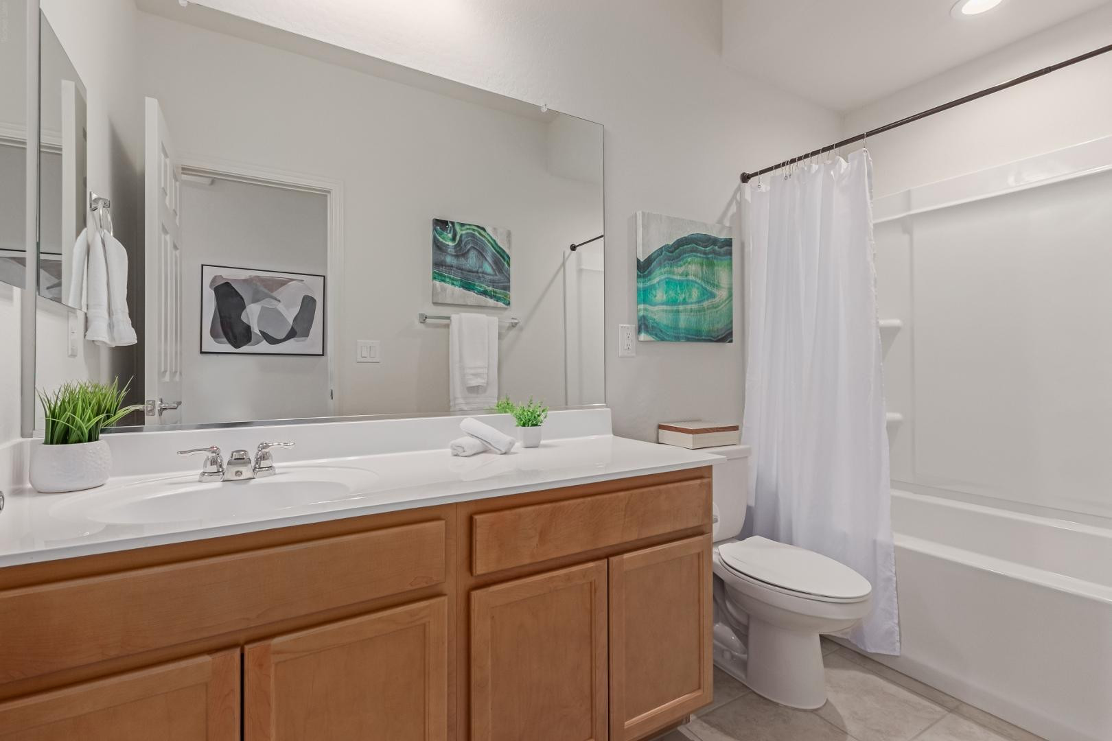 7143 West Coles Road Laveen, AZ 85339 - Photo 13 of 15 a bathroom with a granite countertop sink mirror vanity and toilet