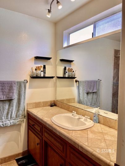 521 Scott Street Ridgecrest, CA 93555 - Photo 23 of 33 a bathroom with a sink and a mirror