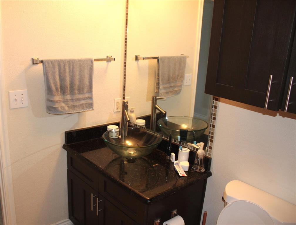 3102 Kings Road, Unit 1207 Dallas, TX 75219 - Photo 11 of 22 a bathroom with a sink and a mirror