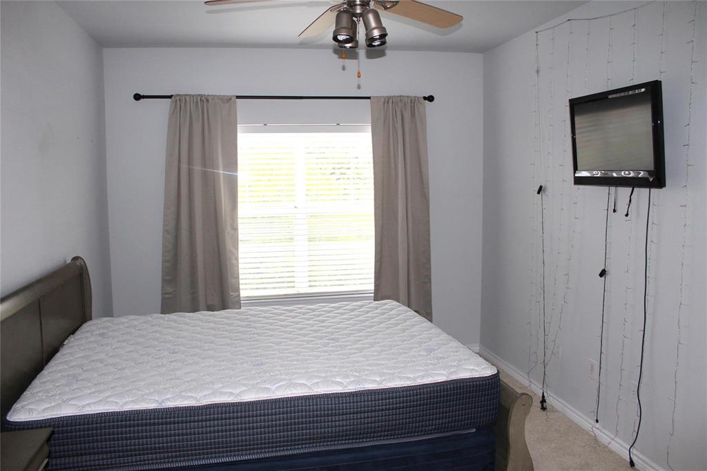 3102 Kings Road, Unit 1207 Dallas, TX 75219 - Photo 14 of 22 a bedroom with a bed and a flat tv screen