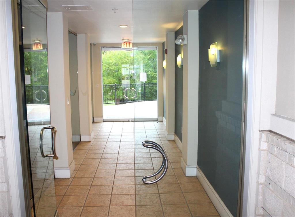 3102 Kings Road, Unit 1207 Dallas, TX 75219 - Photo 3 of 22 a bathroom with a glass shower door and a window