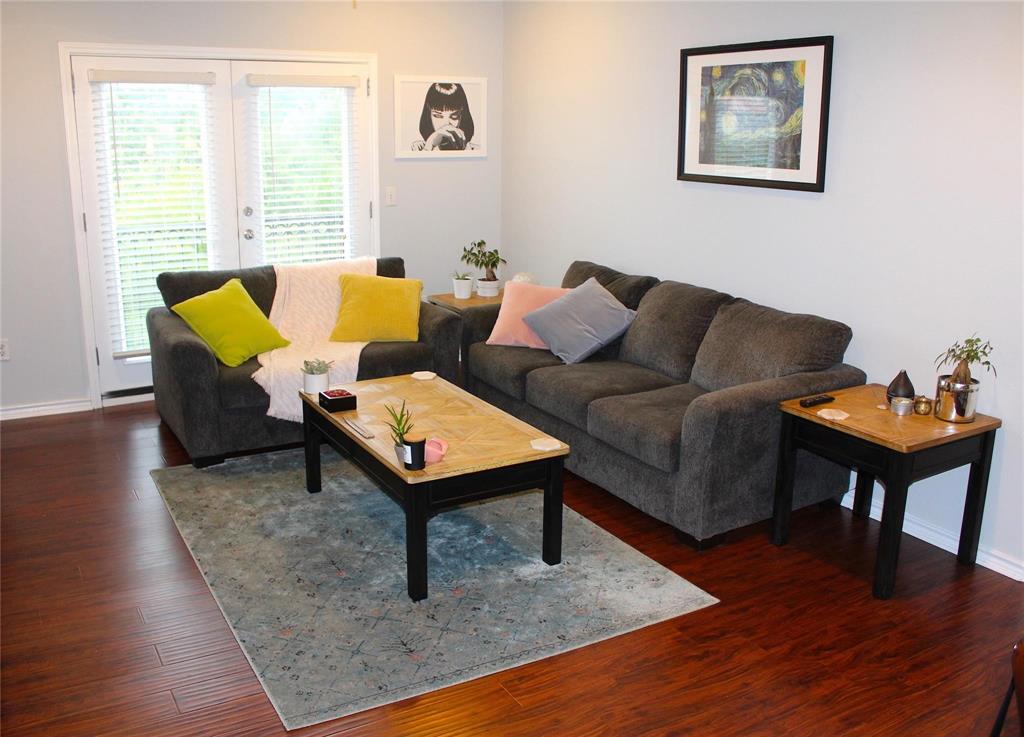 3102 Kings Road, Unit 1207 Dallas, TX 75219 - Photo 6 of 22 a living room with furniture and a wooden floor