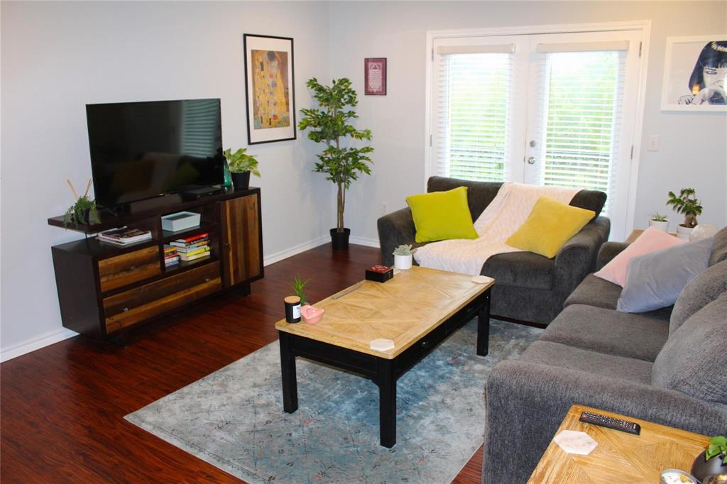 3102 Kings Road, Unit 1207 Dallas, TX 75219 - Photo 7 of 22 a living room with furniture and a flat screen tv