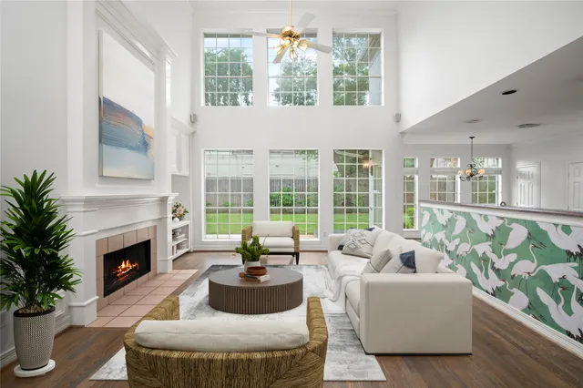a kitchen with stainless steel appliances wooden floor and a window