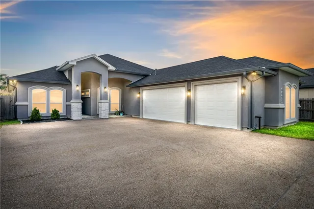 a view of a house with a yard and garage