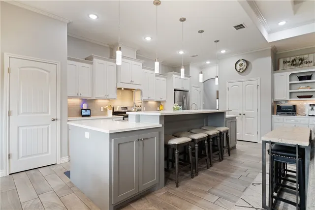 a kitchen with stainless steel appliances kitchen island granite countertop a sink and cabinets