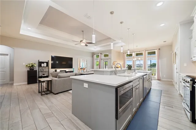 a large kitchen with stainless steel appliances kitchen island granite countertop a large island in the center
