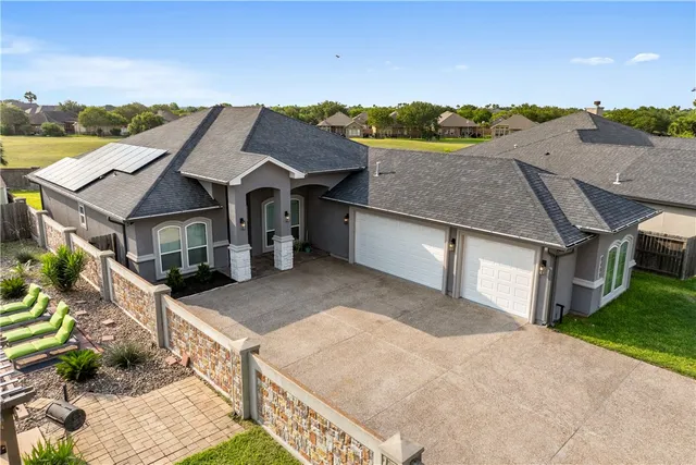a aerial view of a house with a yard and potted plants