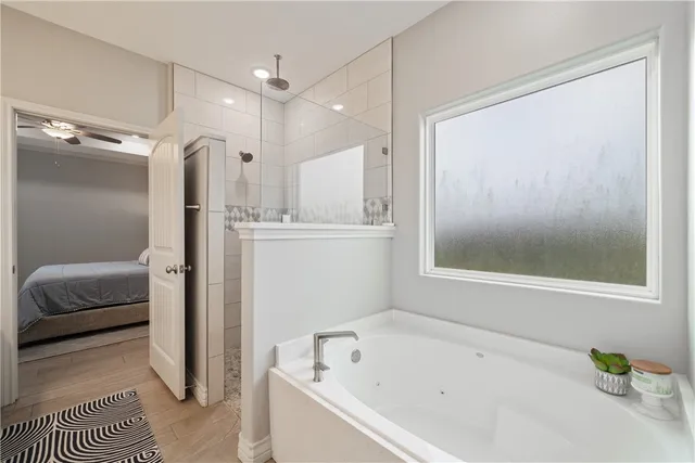 a bathroom with a bathtub and a shower