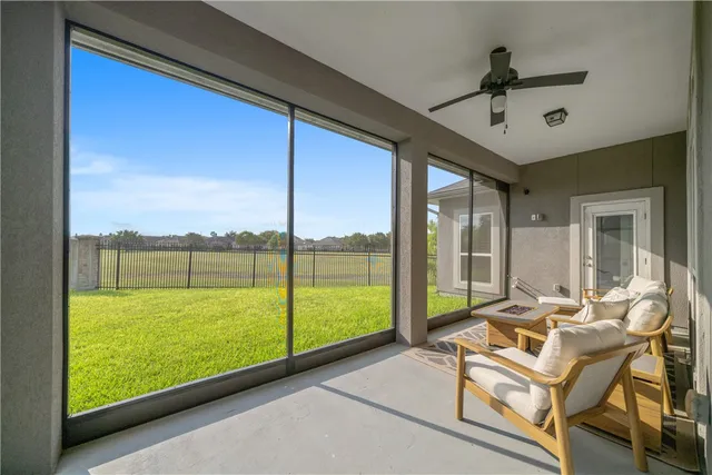 a living room with hardwood floor and ceiling fan