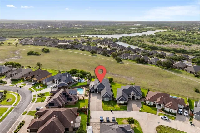 an aerial view of residential building and lake