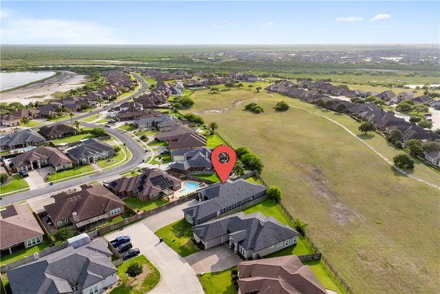 an aerial view of residential houses with outdoor space