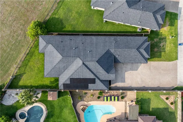 an aerial view of a house with yard