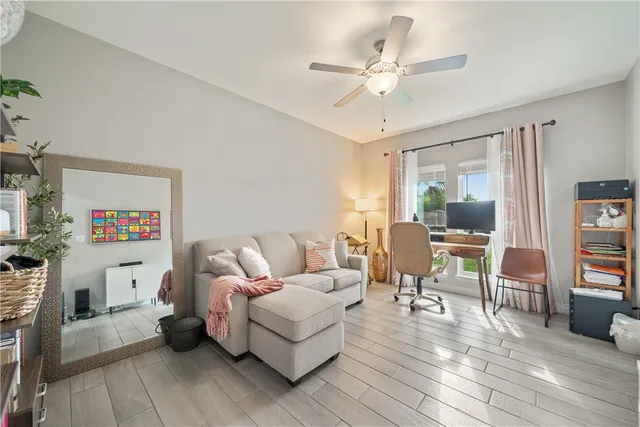 a living room with furniture and a wooden floor