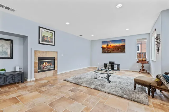 a living room with fireplace furniture and a flat screen tv