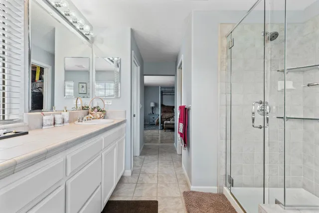 a bathroom with a double vanity sink and a mirror