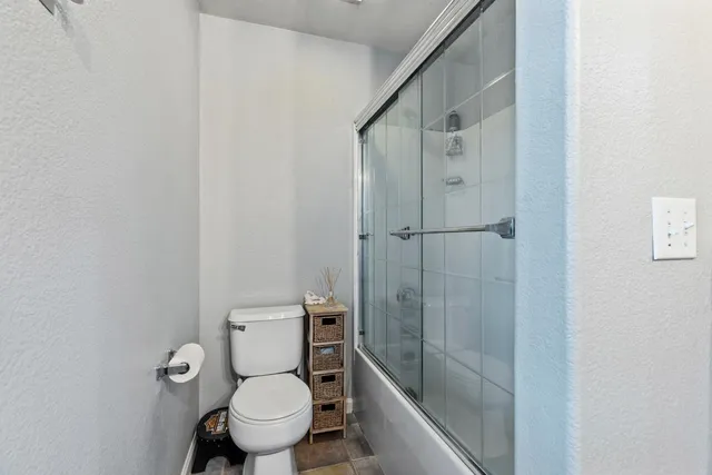 a bathroom with a toilet and shower