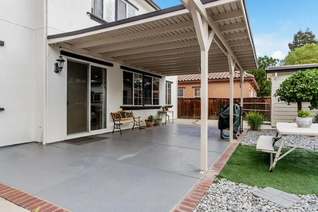 a view of a patio with table and chairs and potted plants