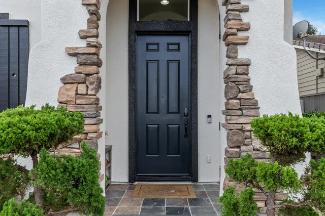 an entrance view of a house with a flower plants