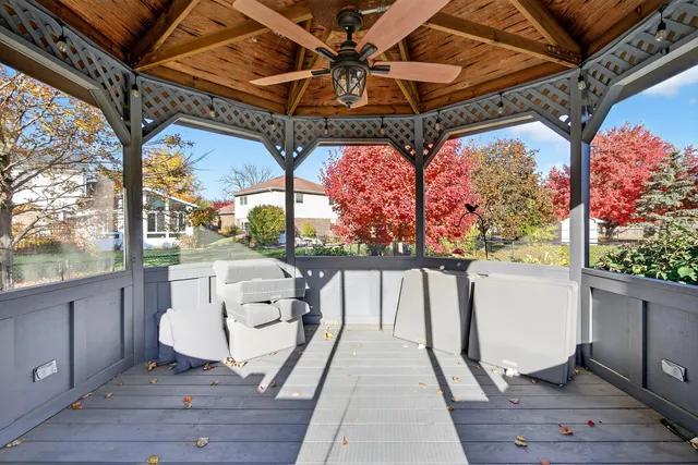 a view of a porch with furniture and a yard