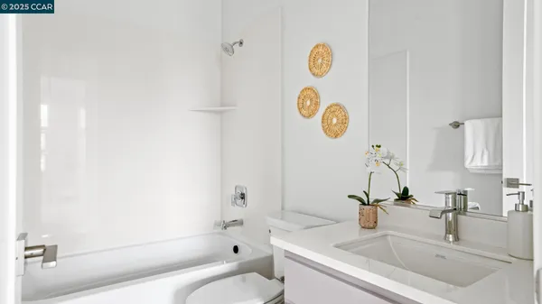 a bathroom with a sink mirror vanity and toilet