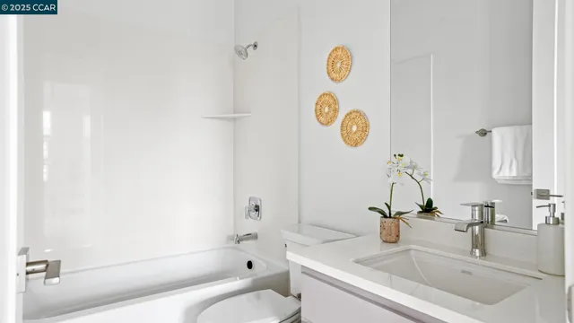 a bathroom with a sink mirror vanity and toilet