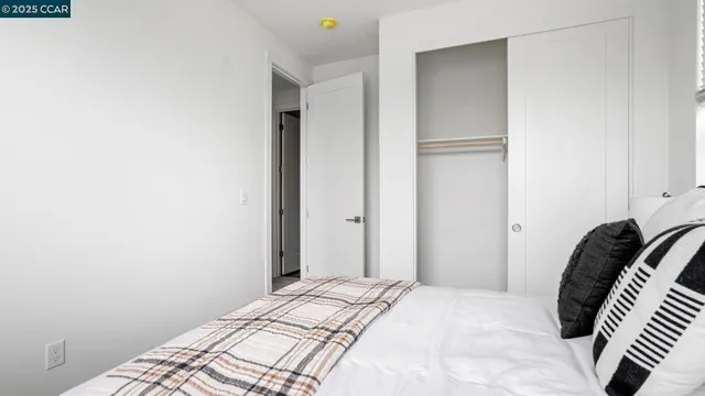 a bedroom with a bed and a rug