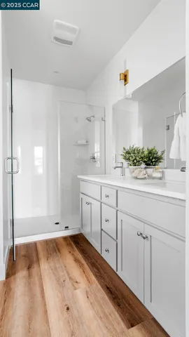 a room with a sink cabinets and wooden floor
