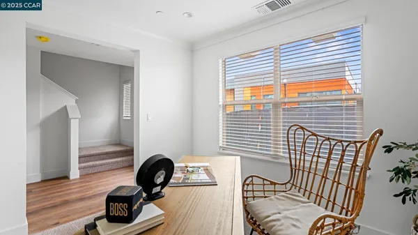 a view of a workspace with furniture and windows