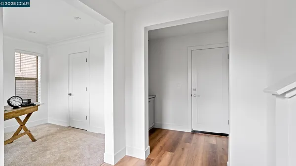 a view of an entryway with wooden floor