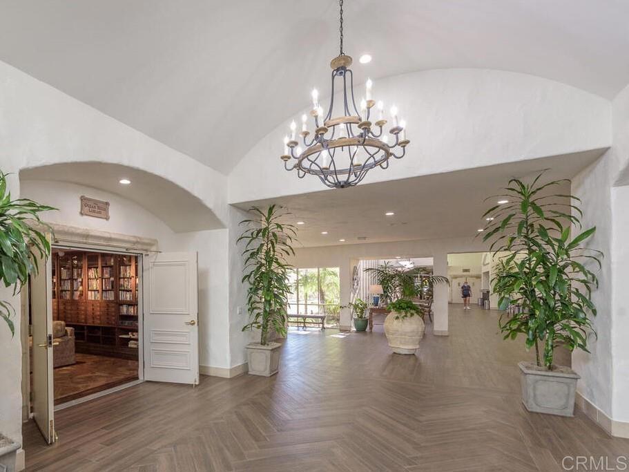 4721 Majorca Way Oceanside, CA 92056 - Photo 15 of 23 a view of a hallway with chandelier and wooden floor