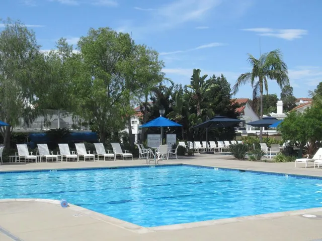 a view of swimming pool with a table and chairs