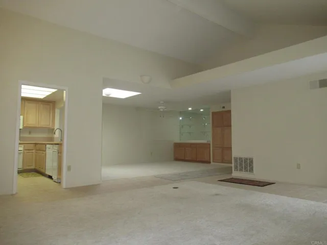 an empty room with a bathroom and sink