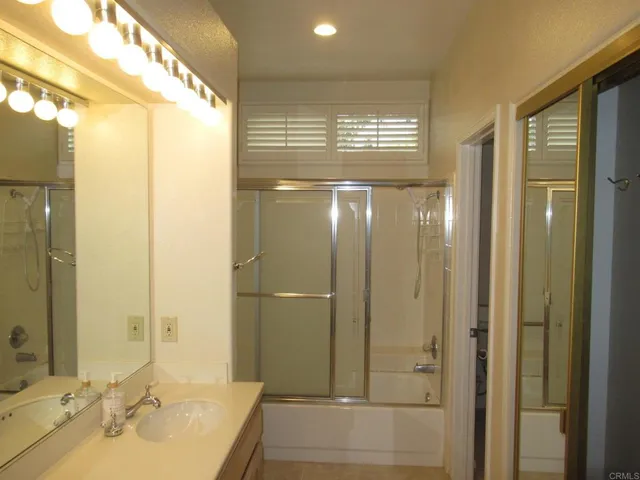 a bathroom with a shower and a sink