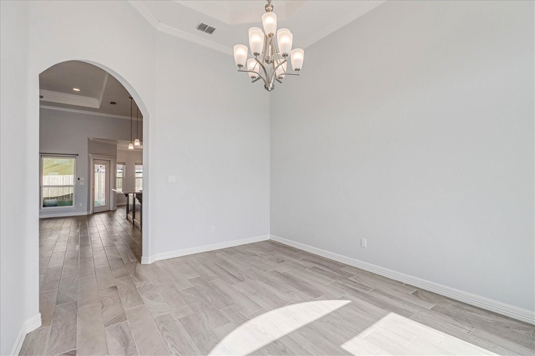 15501 Escapade Street Corpus Christi, TX 78418 - Photo 18 of 40 a view of a hallway with wooden floor and a chandelier