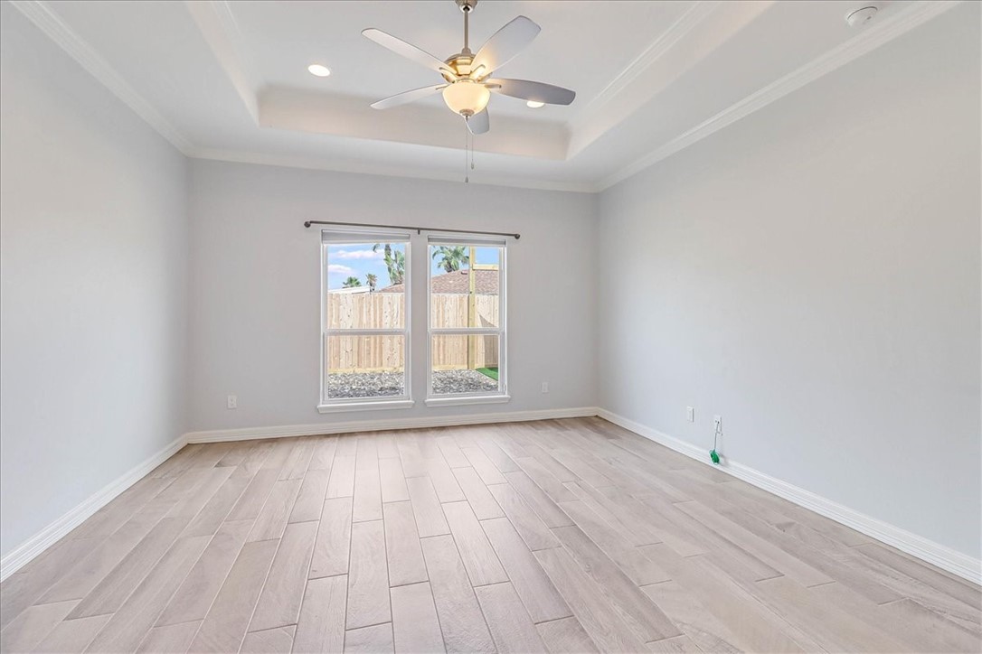 15501 Escapade Street Corpus Christi, TX 78418 - Photo 19 of 40 wooden floor in an empty room with a window