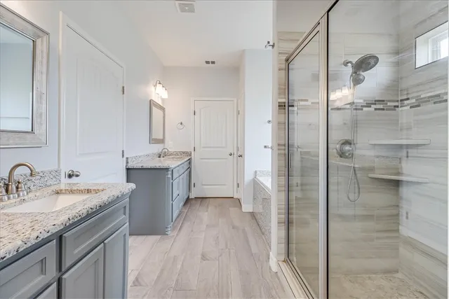 a bathroom with a bathtub and a shower
