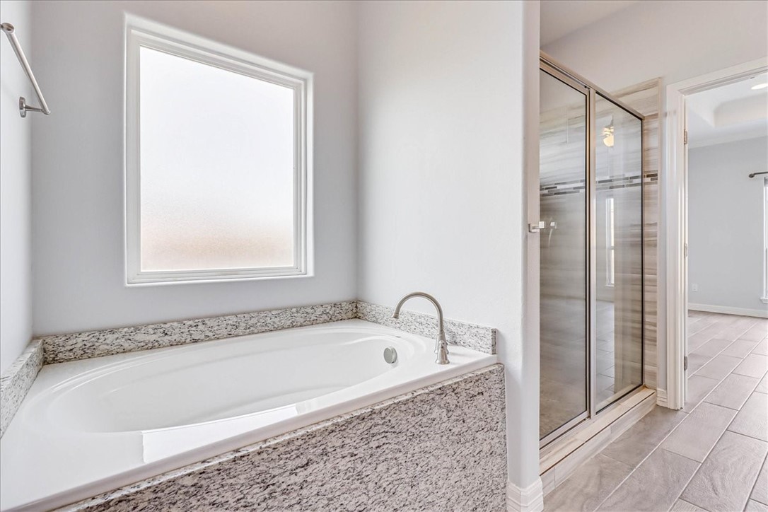 15501 Escapade Street Corpus Christi, TX 78418 - Photo 22 of 40 a bathroom with a bathtub and a shower