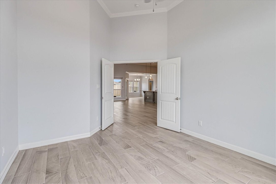 15501 Escapade Street Corpus Christi, TX 78418 - Photo 27 of 40 wooden floor in a hall with an empty room