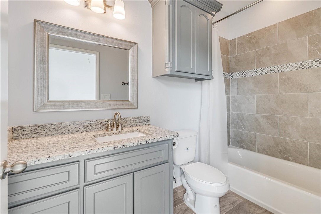 15501 Escapade Street Corpus Christi, TX 78418 - Photo 28 of 40 a bathroom with a granite countertop toilet sink and mirror