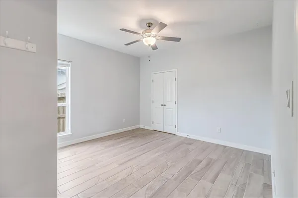a view of an empty room with wooden floor