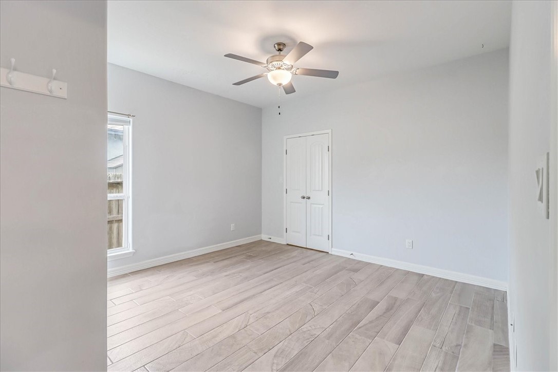 15501 Escapade Street Corpus Christi, TX 78418 - Photo 29 of 40 wooden floor in an empty room with a chandelier fan