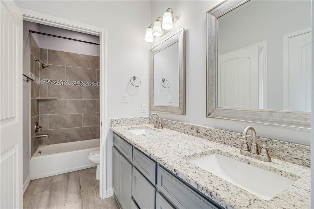 15501 Escapade Street Corpus Christi, TX 78418 - Photo 32 of 40 a bathroom with a granite countertop sink mirror and a bath tub