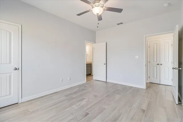 a bathroom with a granite countertop sink and a toilet