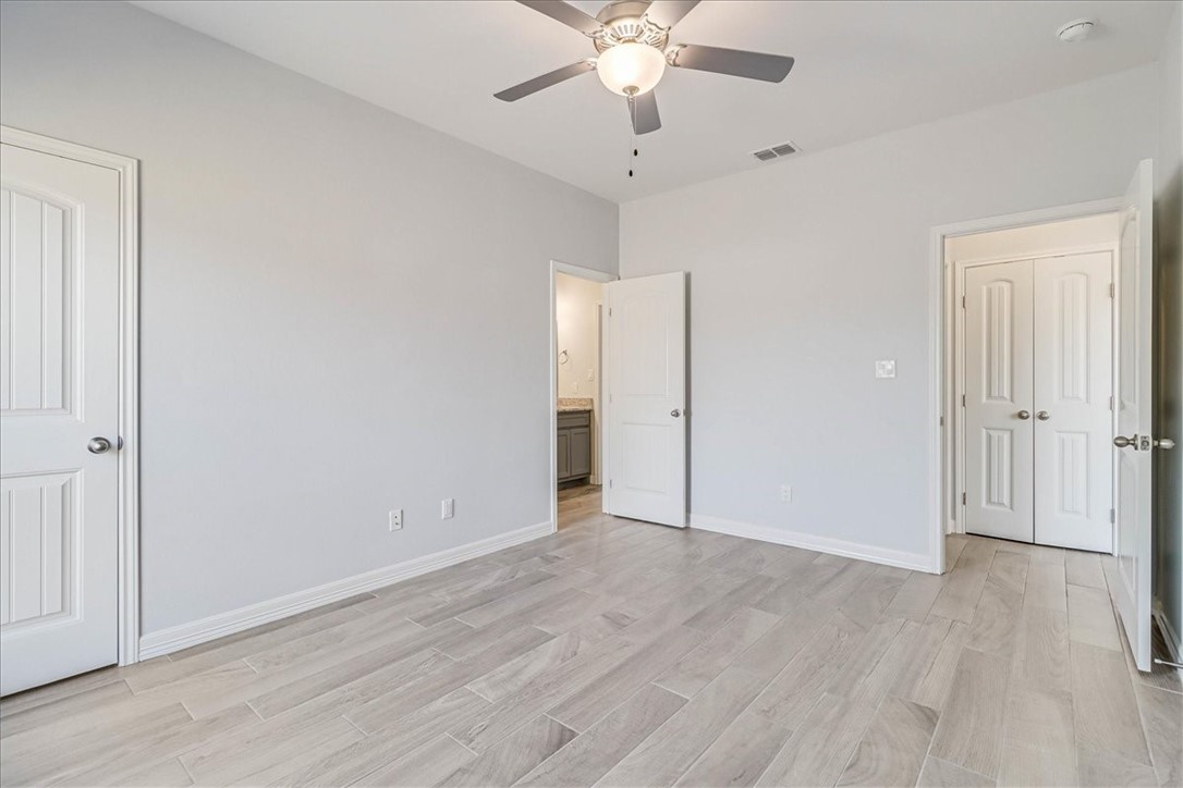 15501 Escapade Street Corpus Christi, TX 78418 - Photo 35 of 40 an empty room with wooden floor and ceiling fan