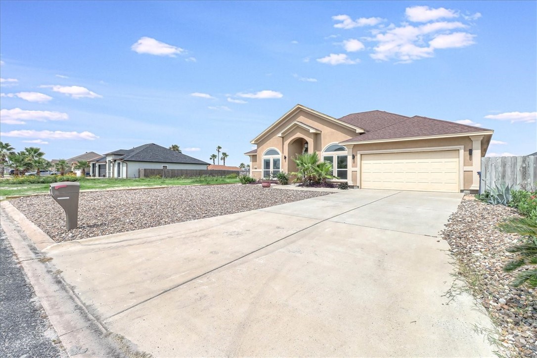 15501 Escapade Street Corpus Christi, TX 78418 - Photo 40 of 40 a front view of a house with a yard and garage