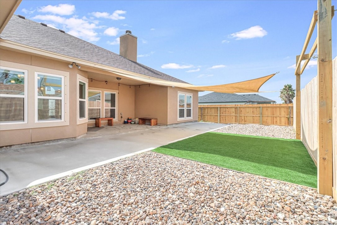 15501 Escapade Street Corpus Christi, TX 78418 - Photo 6 of 40 a front view of a house with a garden and plants
